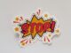 Bright and colorful sticker design featuring a comic-style 'Stop!' sign on a gray background.